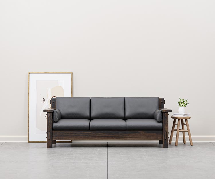 Amish living room sofa with black leather cushions and wood frame.